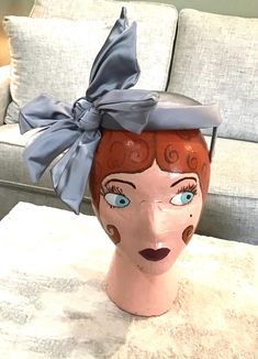 This darling blue/gray satin hat has never been worn. It even has its original price tag! It features three large wired bows. It's in pristine condition. The hat portion is 6 1/4" in diameter. The bows are 7 3/4" in length. Formal Hats With Bow And Adjustable Fit, Formal Hat With Adjustable Bow, Formal Adjustable Hat With Bow, Adjustable Bow Hat For Church, Vintage Gray Hat, Adjustable Evening Hat With Bow, Adjustable Bow Hat For Royal Ascot, Adjustable Hat With Ribbon For Royal Ascot, Adjustable Mini Hats With Bow For Kentucky Derby