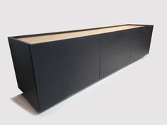 a large black cabinet sitting on top of a white floor