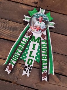 a green and white ribbon with a football player on it