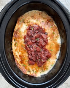 a crock pot filled with food on top of a table