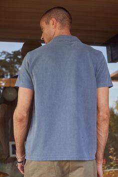 Made from our mid-weight heritage jersey for comfort and durability. With its stylish polo design and short sleeves, this shirt is perfect for any casual occasion. The pigment dyed fabric gives it a vintage look, while the no button placket provides a sleek, simple feel. Navy Casual Polo Shirt Relaxed Fit, Casual Navy Relaxed Fit Polo Shirt, Unstructured Washed Short Sleeve Tops, Blue Cotton Johnny Collar Short Sleeve Shirt, Blue Cotton Short Sleeve Shirt With Johnny Collar, Blue Cotton Short Sleeve Johnny Collar Shirt, Casual Camp Shirt With Polo Collar And Relaxed Fit, Blue Cotton Camp Shirt With Johnny Collar, Blue Cotton Johnny Collar Camp Shirt