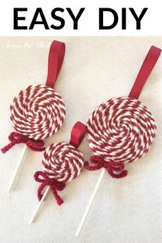 red and white lollipops are sitting on top of each other with ribbons