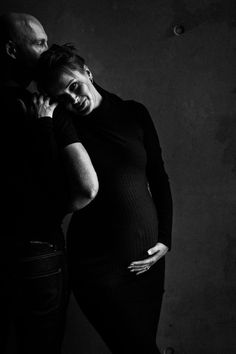 black and white photograph of a pregnant couple