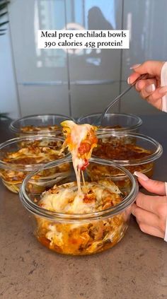 a person is eating some food out of a glass bowl with a spoon in it