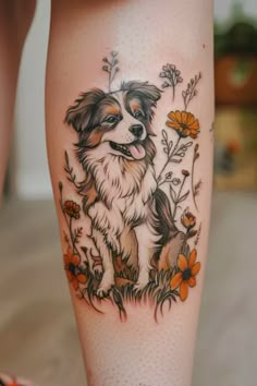 a dog is sitting in the grass with flowers on it's leg and behind its ear