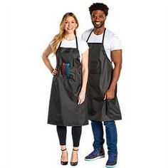 man and woman in aprons standing next to each other