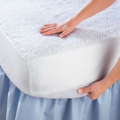 a person is holding the edge of a mattress