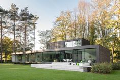 the modern house is surrounded by trees and grass