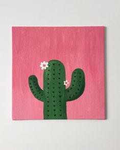 a painting of a green cactus with white flowers on a pink background is featured in the foreground