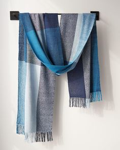 a blue and grey scarf hanging on a wall