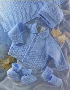 a blue knitted sweater and hat with matching booties