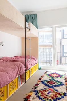 a bedroom with bunk beds and colorful rugs