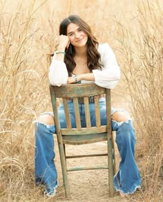 a woman sitting in a chair with her legs crossed