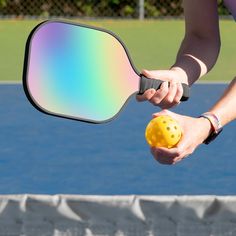 a person holding a tennis racquet with a ball in it's hand