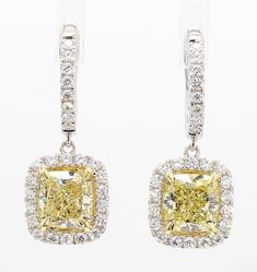 RareGemWorld's classic GIA certified diamond earrings. Mounted in a beautiful 18K Yellow and White Gold setting with natural cushion cut yellow diamonds. The yellow diamonds are surrounded by round natural white diamond melee. These earrings are guaranteed to impress and enhance your personal collection! Total Weight: 5.24cts Natural Light Yellow Cushion Cut Diamond Measurement:  7.25 x 6.90 x 4.72 mm Carat Weight: 2.17cts Clarity Grade: VS1 Natural Light Yellow Cushion Cut Diamond Measurement: 7.39 x 7.06 x 4.75 mm Carat Weight: 2.23cts Clarity Grade: VVS2 Natural Round White Diamonds 18K Yellow/White Gold All diamonds are guaranteed natural International Shipments: Please note that customers are responsible for all import duties and taxes applicable to the country of shipment Returns: Re Yellow Diamond Earrings, Yellow Cushion, Yellow Cushions, Yellow Diamonds, Natural Cushions, White Gold Set, Cushion Diamond, Cushion Cut Diamonds, Gold Drop Earrings