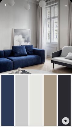 a living room with white walls and blue couches in front of the window, along with gray curtains