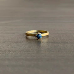 Deep twilight blues glisten in this alluring sapphire stacking ring.

18k yellow gold 
Sapphire, 0.52 carats 4mm (1/8") in diameter Modern Yellow Gold Sapphire Ring With Round Cut, Modern Gold Solitaire Sapphire Ring, Modern Gold Sapphire Solitaire Ring, Yellow Gold Stackable Sapphire Ring, Elegant Gold Stackable Sapphire Rings, Yellow Gold Sapphire Stackable Rings With Bezel Setting, Classic Stackable Sapphire Rings In Yellow Gold, Everyday Gold Stackable Sapphire Ring, Yellow Gold Blue Topaz Round Band Rings