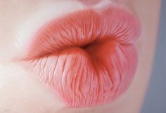 a close up view of the inside of a person's mouth with pink lipstick on it