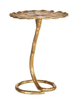 a gold table with a curved base and a leaf design on the top, against a white background