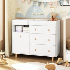 a baby's room with a teddy bear on the dresser