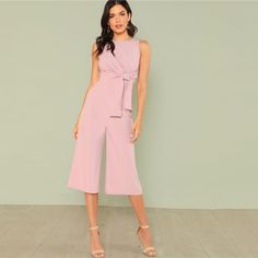 This chic sleeveless jumpsuit is simply perfect. Featuring an empire waist with a knotted sash bow and flared ankle pants. This jumpsuit pairs perfectly with wedges, heels or sandals. Made with a polyester and spandex blend for comfort and style. Women Jumpsuit Outfits Dressy, Pink Jumpsuit Outfit Classy, Pink Jumpsuit Outfit, Pink Jumpsuits Outfit, Women Jumpsuit Outfits, Work Outfit Inspiration, Women Jumpsuit, Culotte Jumpsuit, Jumpsuit Elegant