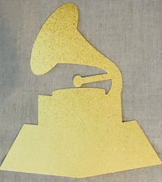 an image of a yellow musical instrument cut out from paper on a piece of cloth