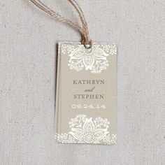 wedding tags with lace are hanging from twine