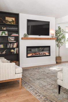 a living room with a couch, chair and fireplace