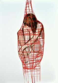 a woman is wrapped in red string