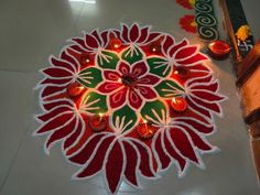 a decorated diya with candles on the floor