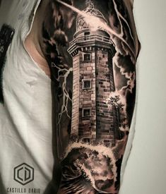 a man's arm with a lighthouse and storm coming in from the ocean on it