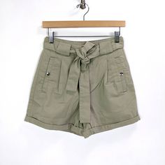 Please Check The Measurements Below To Make Sure It's A Perfect Fit For You Miss Selfridge Womens Waist Tie Paperbag Denim Shorts - New With Tags - Size 4 - Color: Khaki Green, Sage Green, Grayish Green - 65% Cotton, 35% Recycled Polyester - Tie Waist - Rolled Hem - Front Pockets With Snap Button Closure - Faux Back Pocket - Waist 13 1/4" - Hips 18 3/4" - Length 14 3/4" - Rise 12.5" - Inseam 3 1/4" High Rise Workwear Shorts With Belt Loops, High-waisted Khaki Shorts For Work, Cotton Workwear Shorts With Paperbag Waist, Khaki Shorts For Workwear In Spring, Utility Jean Shorts For Spring, Spring Utility Cargo Shorts, Chic High Rise Shorts With Pockets, Utility Jean Shorts With Built-in Shorts For Summer, Workwear Shorts With Pockets And Paperbag Waist