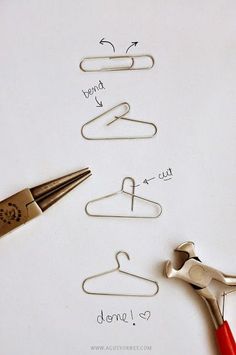 scissors and paper clips are sitting next to each other on a sheet of paper that has been drawn