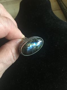 This is a very unique ring I purchased in a vintage jewelry auction. Set in the antique silver plated setting is one beautiful chunk of oval BLUE LABRADORITE gemstone. The stone is a beautiful oval stone as you can see in the photo's. The ring is stamped 925 (very difficult to see, but it's there). The ring shows very little wear... mint condition! The ring is sterling silver with a copper base.   Ring Size: 7.5 Blue Labradorite Ring, Luxury Oval Labradorite Ring, Unique Oval Labradorite Jewelry, Unique Blue Labradorite Ring, Unique Labradorite Ring With Large Stone, Adjustable Cabochon Labradorite Ring, Jewelry Auction, Bagan, Ring Vintage