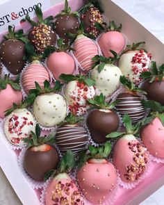 chocolate covered strawberries are arranged in a pink box