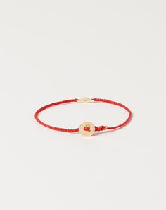 Scosha 2mm evil eye bracelet features gold tiny eye charm accented with 1mm turquoise stone on braided waxed nylon in scarlet. Gold signature button closure. Dimensions: 6.75" long Material: Nylon, 10k gold, turquoise Origin: Brooklyn, NY Why we Covet: Beautifully simple Adjustable Yellow Gold Bracelets With Charms, Everyday Yellow Gold Evil Eye Bracelets, Adjustable Yellow Gold Evil Eye Bracelet, Adjustable Evil Eye Jewelry For Everyday, Dainty 14k Gold Adjustable Evil Eye Bracelet, Dainty Adjustable 14k Gold Evil Eye Bracelet, Adjustable 14k Gold Dainty Evil Eye Bracelet, Adjustable Dainty 14k Gold Evil Eye Bracelet, Eye Bracelet