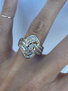 The gorgeous classic ring holds marquise cener diamond of approximately .20ct P/SI1 and round genuine diamonds of approximately .60ctw H-I/SI1-I1. This ring is a lot of look for the money! There is a notch on one side of the head where there was once a hidden wedding band. It is shown in the pictures when laying on the side. It is not easily seen when worn. Ring weighs 7.5g and measures 19mm at its widest point. It is stamped and guaranteed to be 14k yellow gold. Ring size 7 and sizable.  I can size it for an additional charge.  Let me know if you need a quote. Fine Jewelry Marquise Diamond Ring Vs Clarity, Fine Jewelry Marquise Diamond Ring With Vs Clarity, Marquise Diamond Ring With Vs Clarity, 14k Gold Marquise Diamond Ring With Center Stone, Marquise Cut Diamond Topaz Ring With Prong Setting, Marquise Diamond Topaz Ring For Anniversary, Gold Marquise Topaz Ring For Anniversary, Diamond Jewelry With Vs Clarity In Marquise Shape, 14k Gold Marquise Cut Diamond Ring With Accents