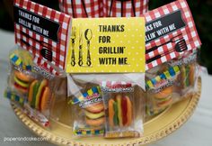 there are some food items in bags on the table with red and white checkered napkins