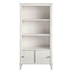 a white bookcase with two drawers and one door on the bottom, in front of a