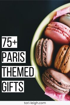 a bowl filled with lots of different types of macaroons in it and the words 75 + paris themed gifts