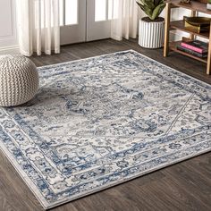 a blue and white area rug in a living room