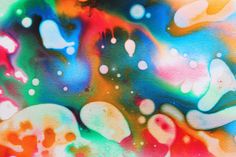 an abstract painting with lots of colors and bubbles in the air on a black background