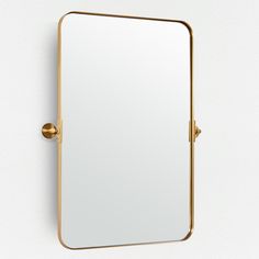 a gold framed mirror on the wall