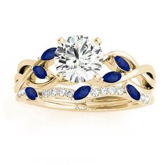 a diamond and blue sapphire wedding set with an oval center stone in 18k yellow gold