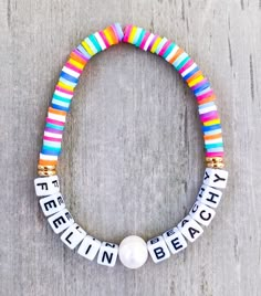 Feelin Beachy Bracelet ️  Made with rainbow mini heishi beads, 18k gold spacers, salt water pearl, and mini square letters that read "Feelin Beachy" If you would like another word, please put in Personalization Section* CARING TIPS FOR YOUR JEWELRY ⭐️Treat and store with care. ⭐️ For longevity, avoid exposing your jewelry to water. ⭐️ Avoid having direct contact with lotions, perfumes, sanitizers as these chemicals  may cause discoloration of your jewelry. Multicolor Beaded Bracelets For Holiday, Adjustable Multicolor Jewelry For Holiday, Rainbow Bracelets With Letter Beads For Festivals, Rainbow Letter Beads Bracelet For Festival, Rainbow Letter Beads Bracelet For Festivals, Adjustable Multicolor Bracelets For Holiday, Adjustable Multicolor Bracelet For Holiday, Adjustable Multicolor Beaded Bracelets For Holiday, Rainbow Letter Beads Friendship Bracelets For Beach