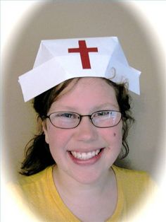 a girl wearing a paper crown with a cross on it