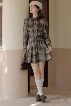 Long sleeve button front shirt dress with a classic collar, faux chest pockets, belted waist and mini pleated skirt in a plaid flannel fabric. Lined. Only top half of buttons are functional with a concealed side zipper closure. Belt included. S: 13" across shoulders, 36" chest, 26" waist, 31" lengthM: 13.5" across shoulders, 37.5" chest, 27.5" waist, 31" lengthL: 14" across shoulders, 39" chest, 29" waist, 31.5" lengthXL: 14.5" across shoulders, 40.5" chest, 30.5" waist, 31.5" length Brown Flannel Shirt Outfit, Fall Collared Shirt Dress With Belted Cuffs, Collared Shirt Dress With Belted Cuffs For Fall, Casual Brown Plaid Dress For Fall, Preppy Plaid Dress For Fall, Belted Mini Shirt Dress For Fall, Belted Mini Length Shirt Dress For Fall, Long Sleeve Brown Plaid Dress For Fall, Casual Pleated Shirt Dress For Fall