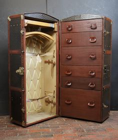 an old fashioned wooden jewelry box opened to show the inside and outside compartments with drawers