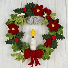 a crocheted wreath with a lit candle in the middle and holly leaves around it