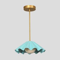 a blue and gold light hanging from a ceiling fixture with a heart shaped shade on it